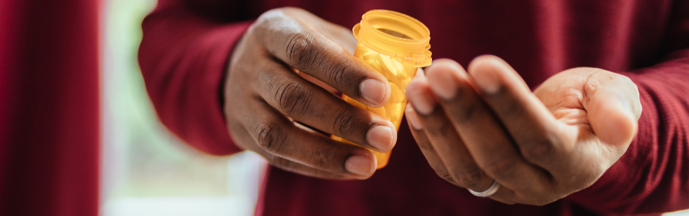 hands holding prescription bottle hands holding prescription bottle