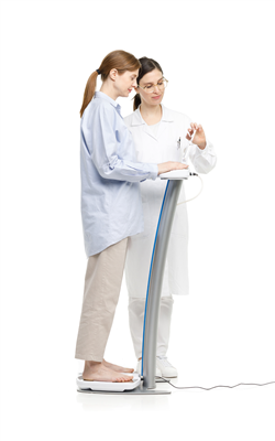 sozo.png image of a woman using L-Dex machine while a second woman helps