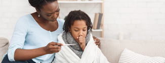 Mother taking her daughters temperature.